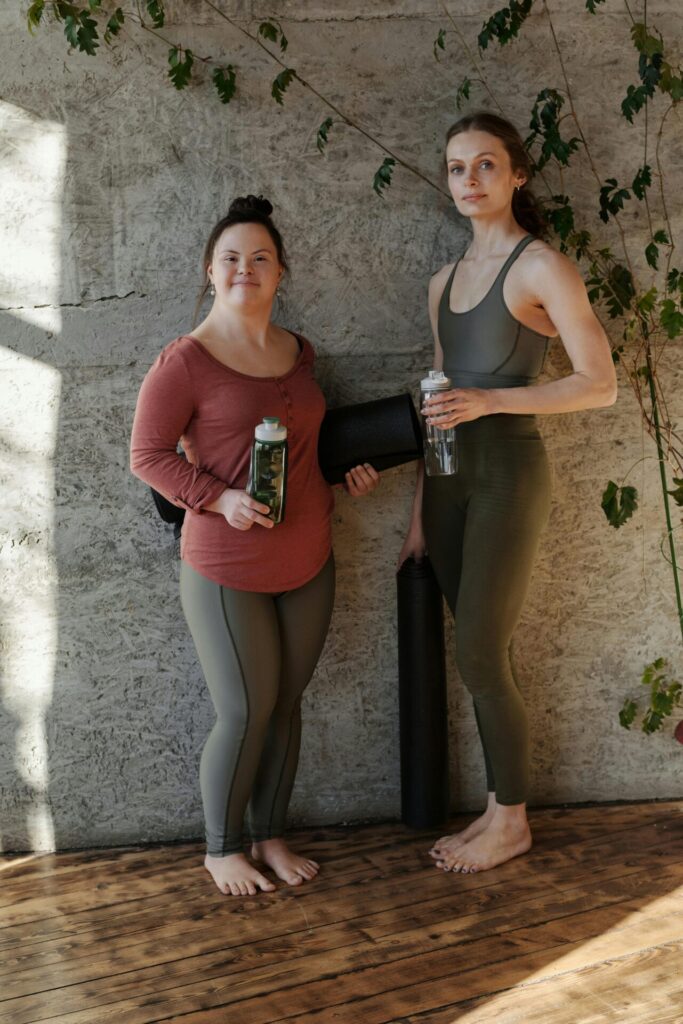 a girl with downs syndrome preparing for a yoga class