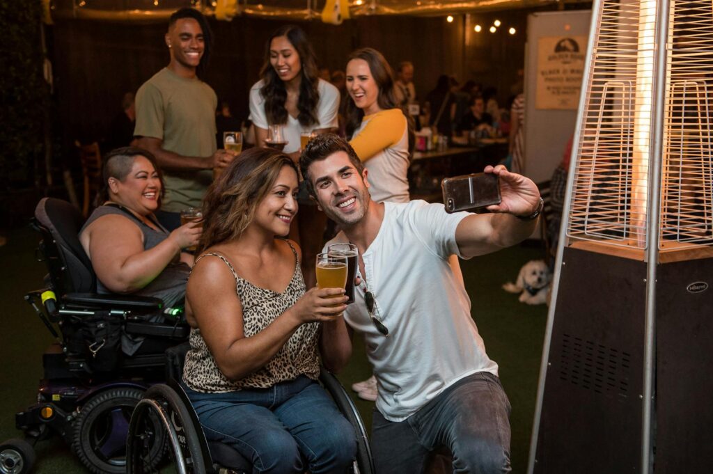 women win wheelchairs at party taking pictures