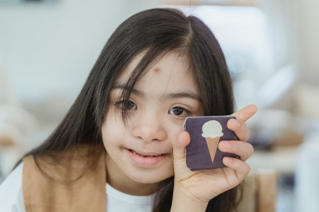 girl with down syndrome showing a picture of a ice creme