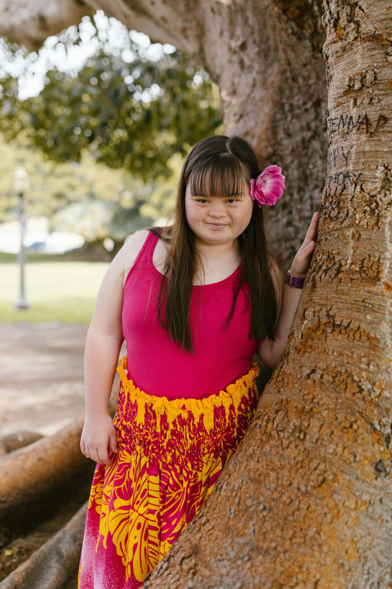 disabled girl in a hula outfit by the tree