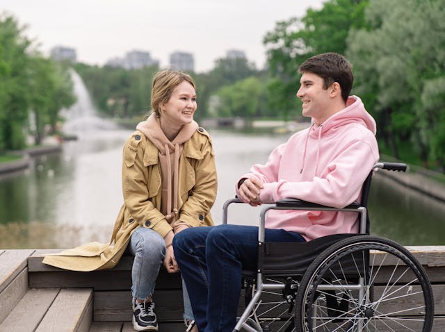 disabled couple talking by the lake